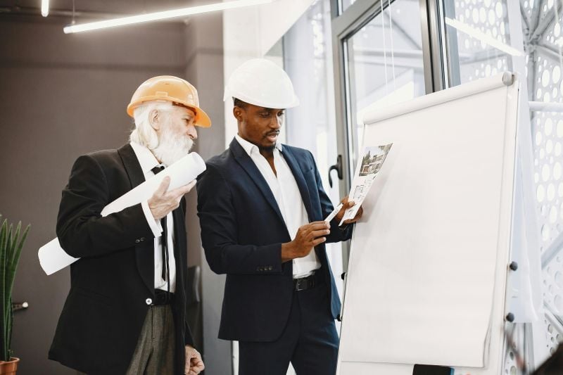 A BIM coordinator going through a project plan with a senior