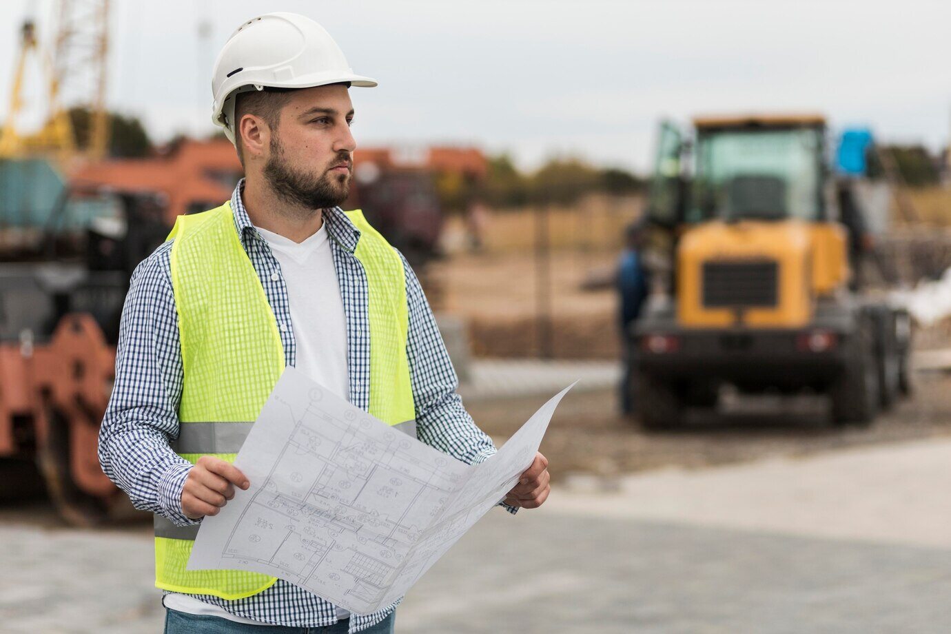 A Construction Engineer analysing the blueprint 