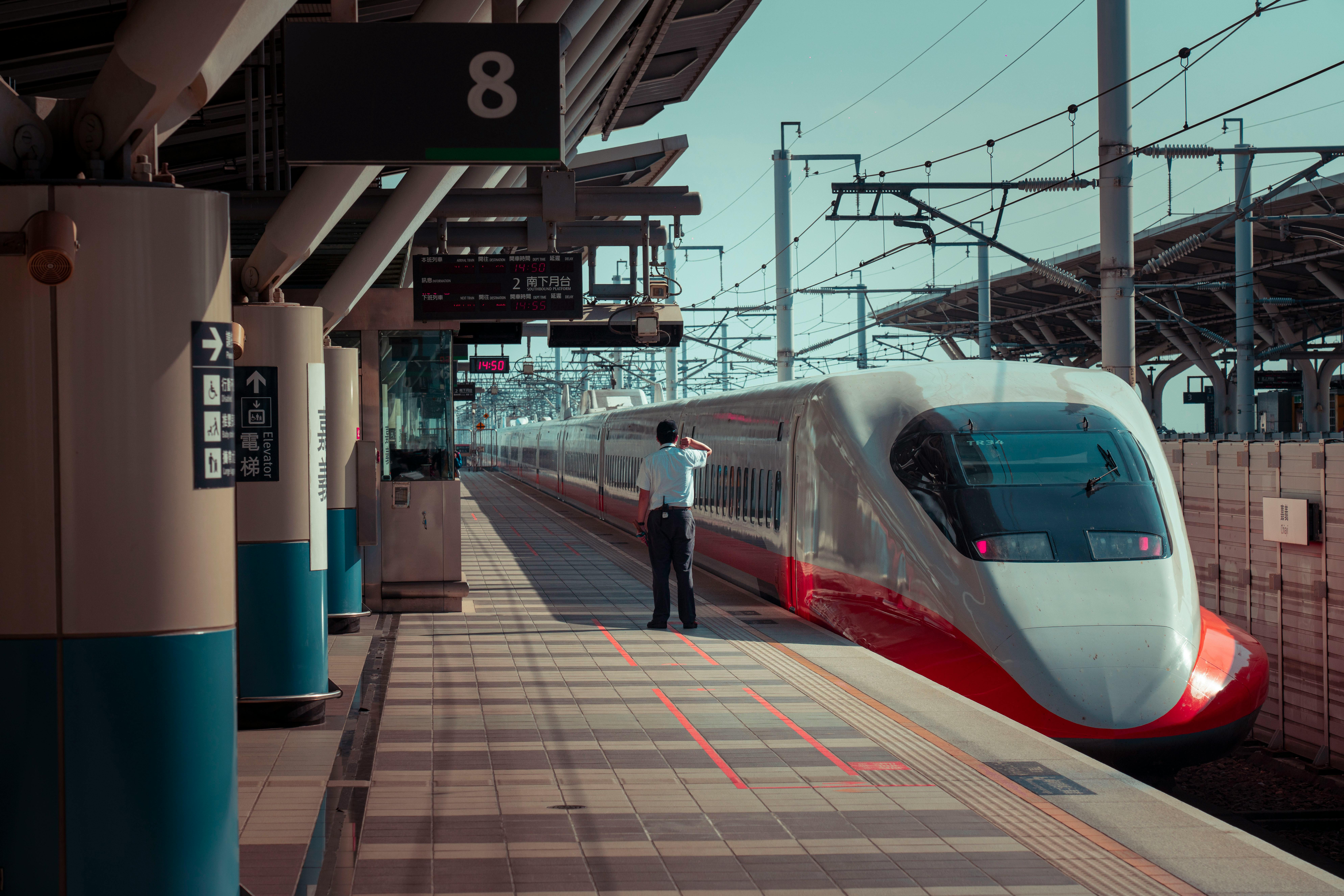 A High Speed Rail train stopped at a station platform.