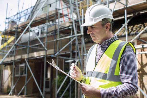 A construction inspector inspecting reports