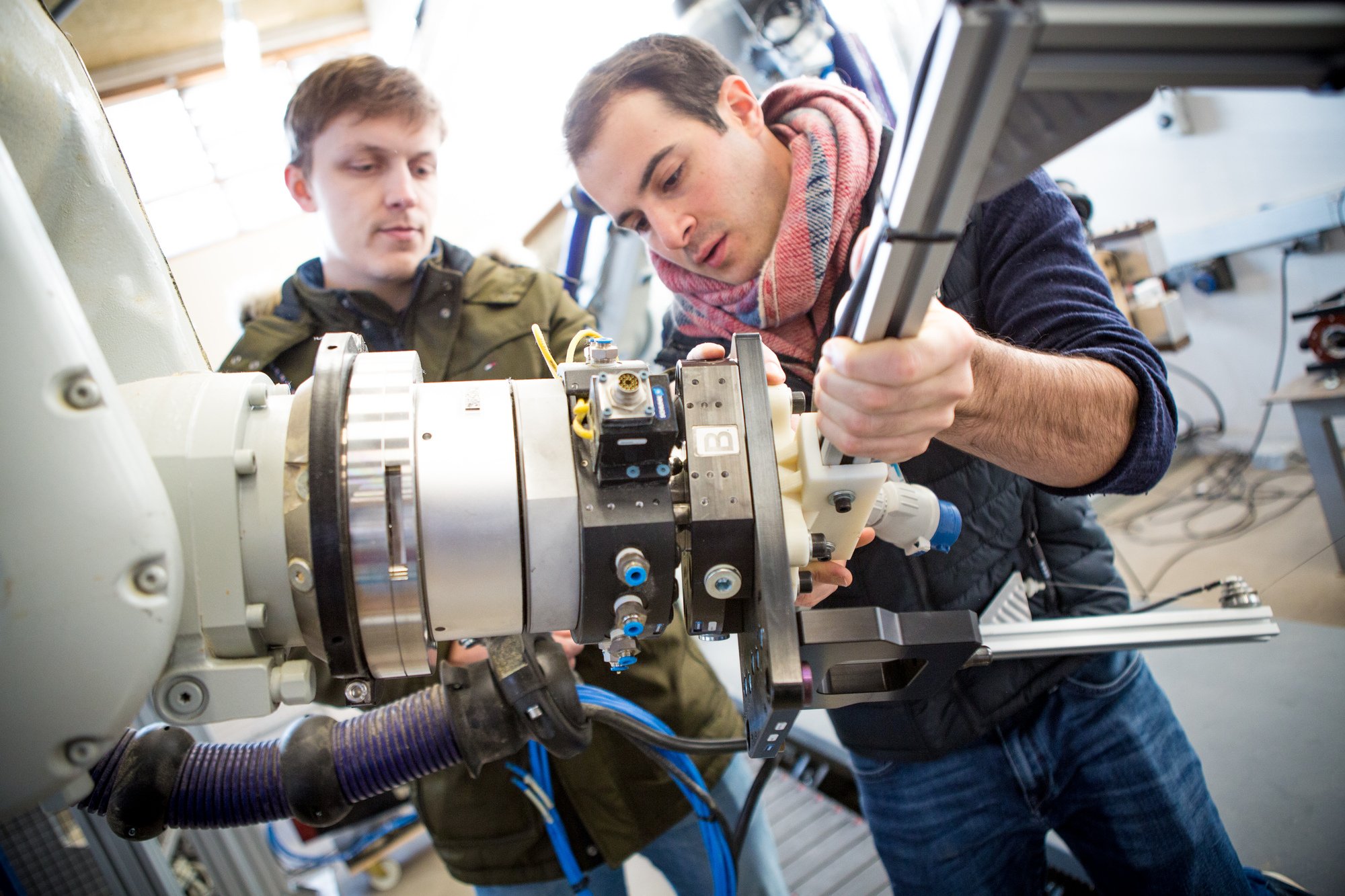 A digital fabrication specialist operating machinery