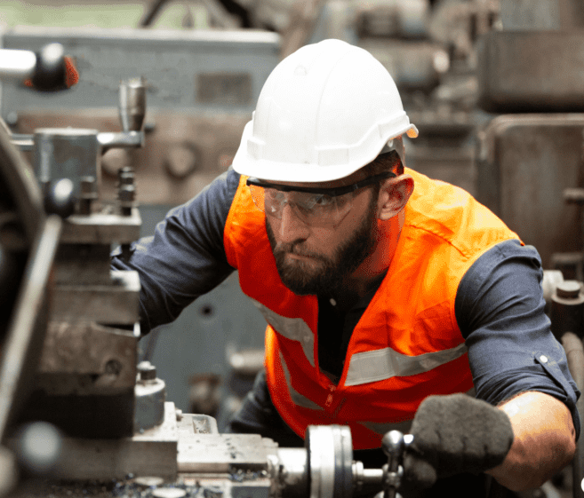 A manufacturing Engineer working on the machine-