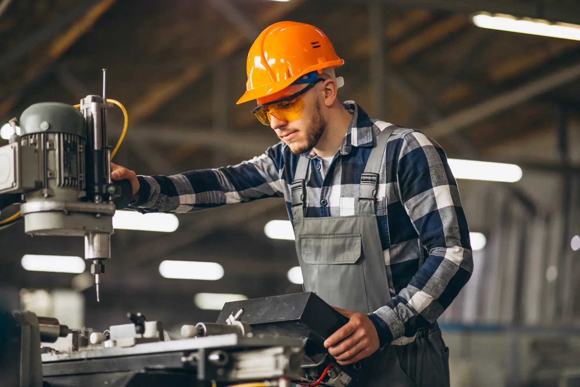 A mechanical engineer operating a machine.