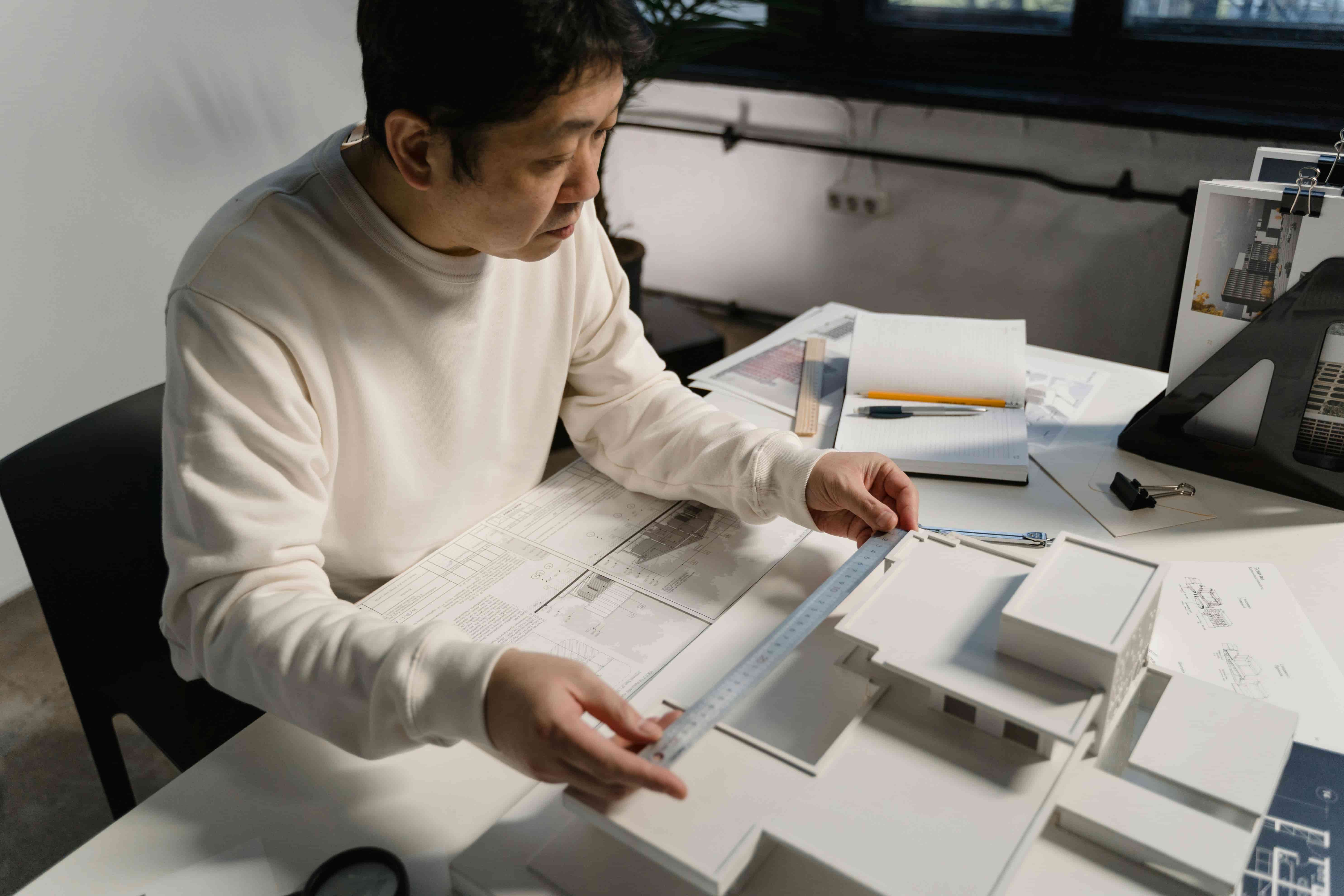An architectural technician measuring a scale