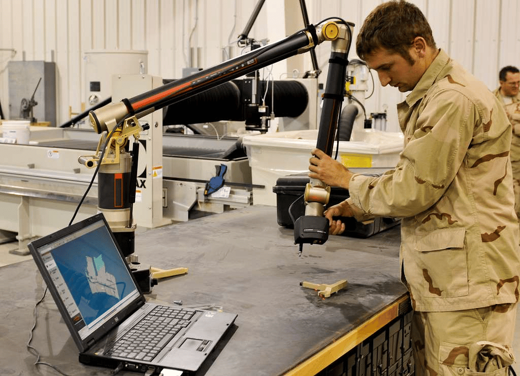 An engineer using 3D scanning equipment for modeling.