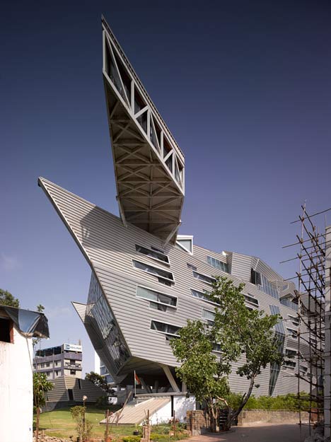 An image showing the faceted exterior of GMS Grande Palladium with tessellated glass panels