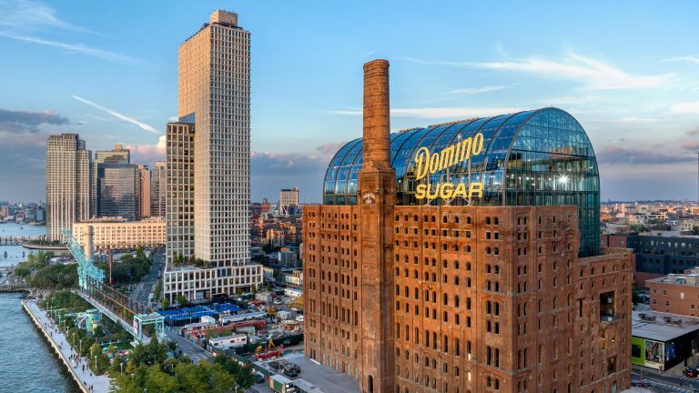 An image showing the restored Domino Sugar Refinery with a new glass vault structure