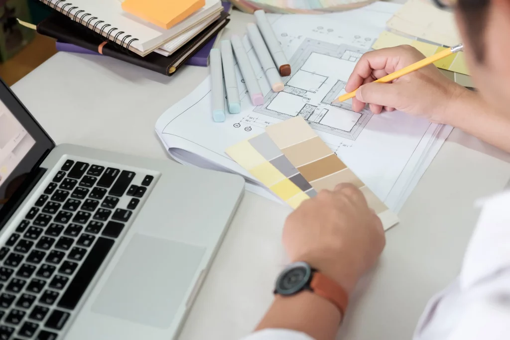 An interior designer demarcating a detail on a layout-1