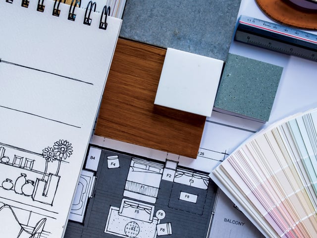 An interior designer’s desk with sketches and material samples