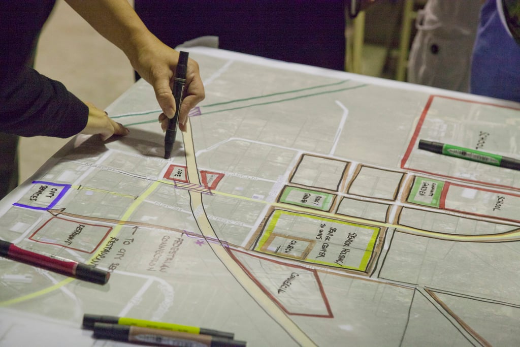 An urban planner making marks on a project sheet