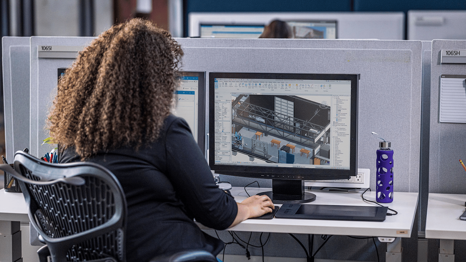 Architect editing building model on computer.