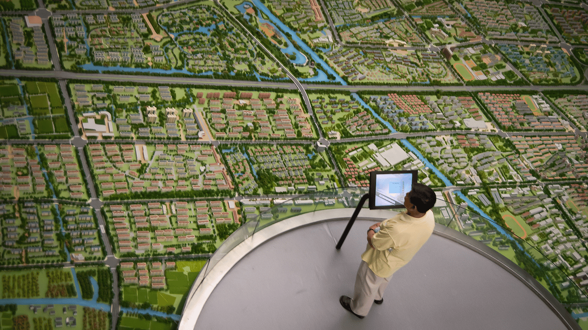 Architect examining a detailed city development layout.