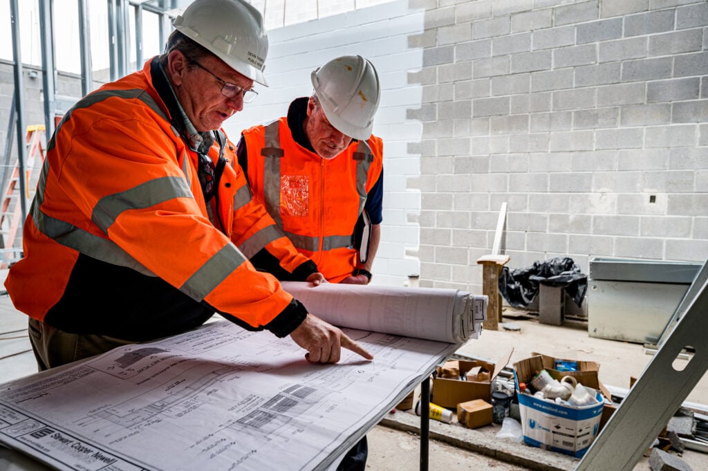 BIM Modelers reviewing a project on a white sheet