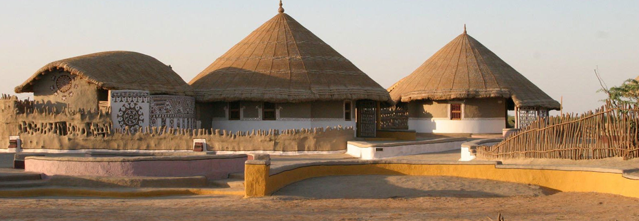 three units of Bunga Houses of Kutch with a staircase leading to the units