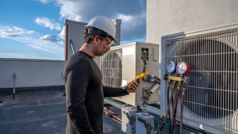 Building Performance Analyst conducting HVAC controls inspection.