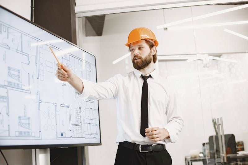 Certified site manager presenting blueprint
