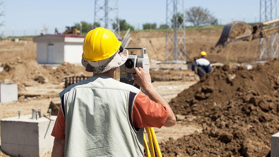 Civil engineer surveying the site