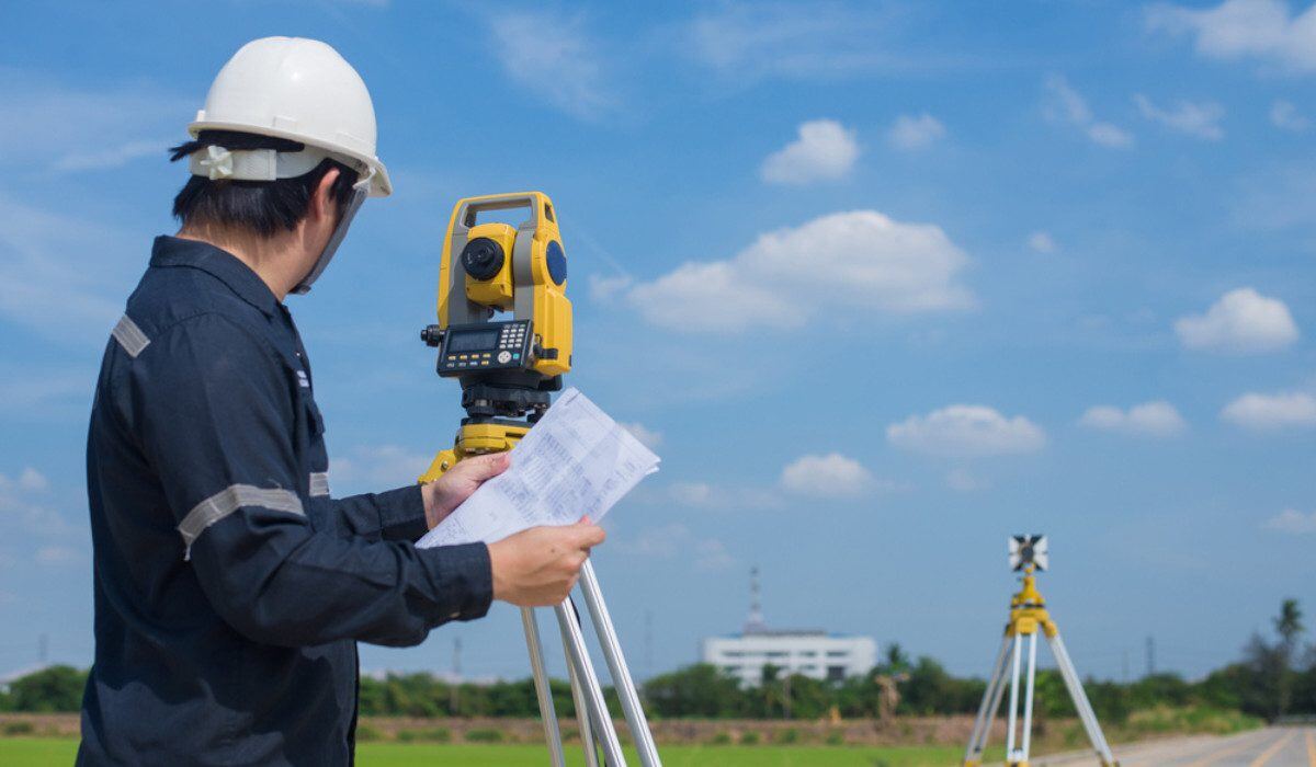 Civil engineer using a theodolite survey instrument