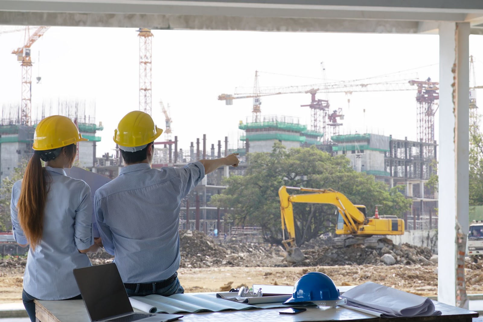 Civil engineers discussing a project in the field