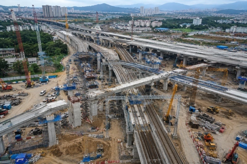 Complex highway and railway infrastructure under construction.