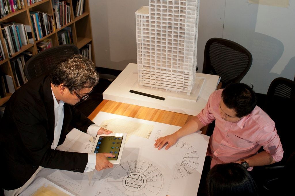 Computational designers analysing a building plan with modern technology