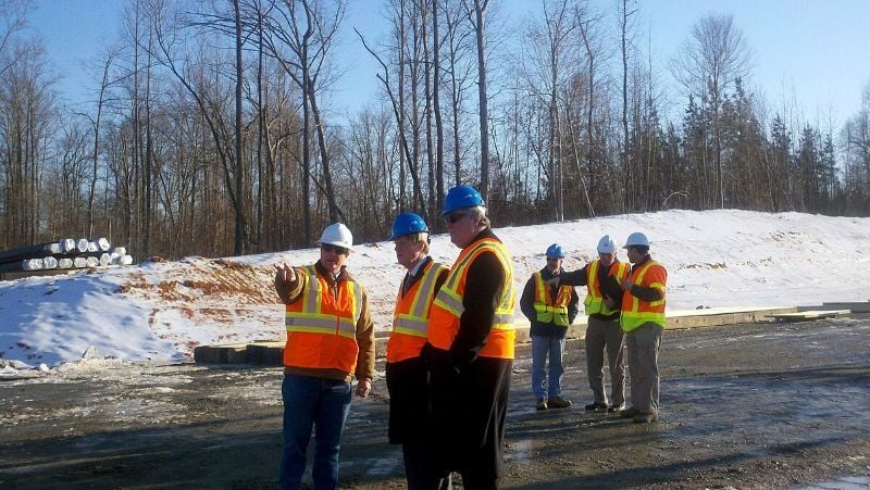 Construction Managers coordinating on-site activities and reviewing plans with the crew