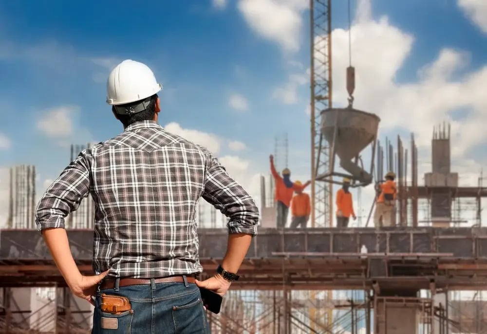 Construction engineer supervising work on site