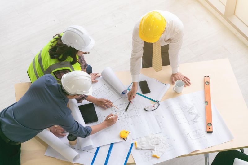 Construction engineers planning having discussion
