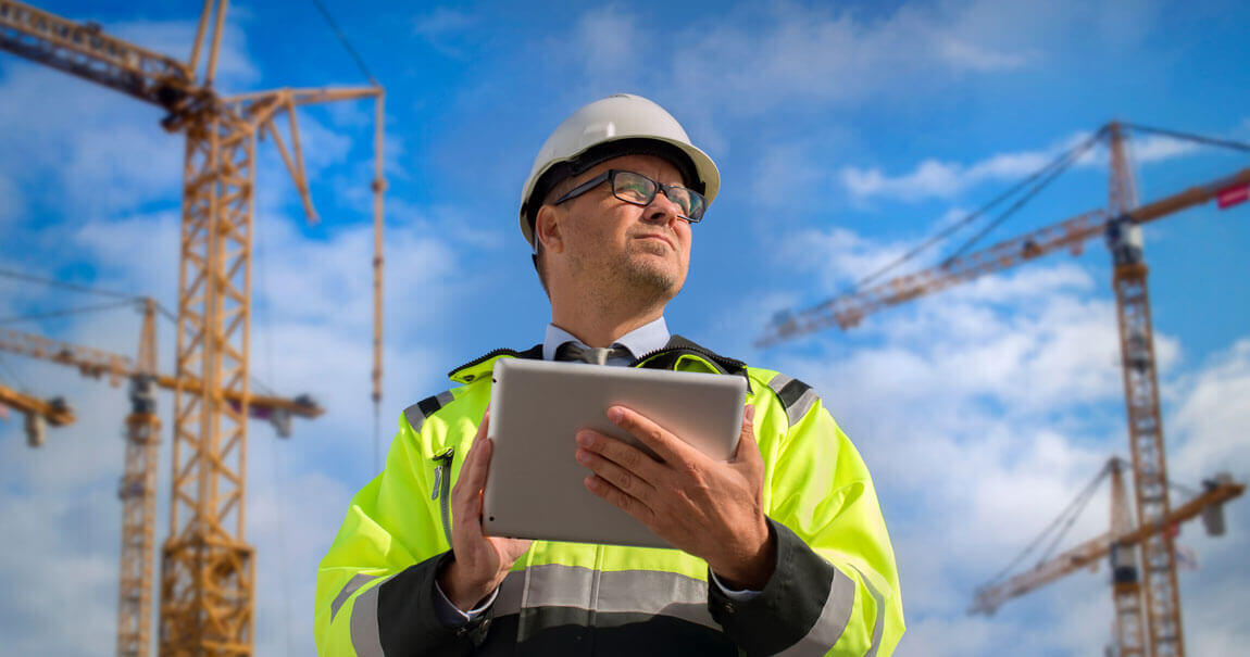 Construction inspector reviewing drawings on site