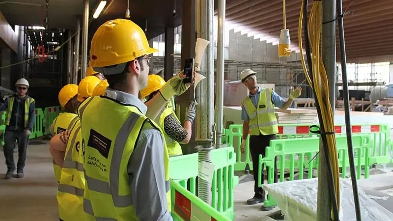 Construction team inspecting building site progress