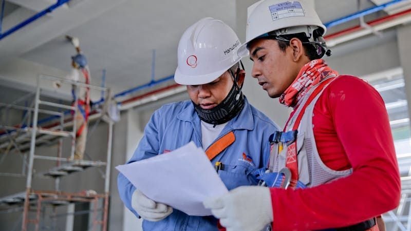Construction workers reviewing plans