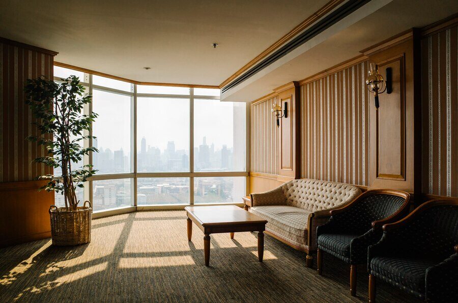 Contemporary living room area with wooden design on wall a big window