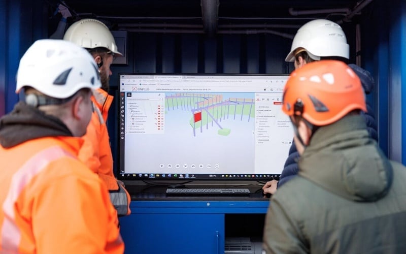 Engineer analyzing BIM building model on computer.