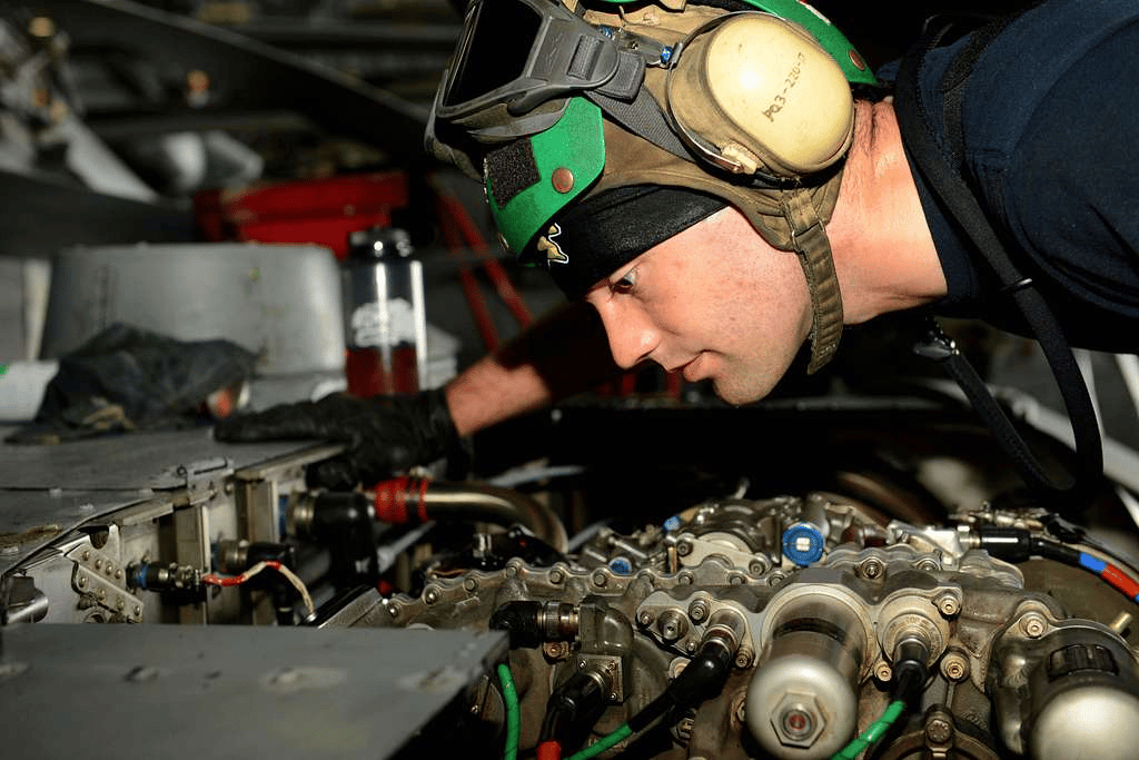 Engineer inspecting mechanical equipment and internal building systems.