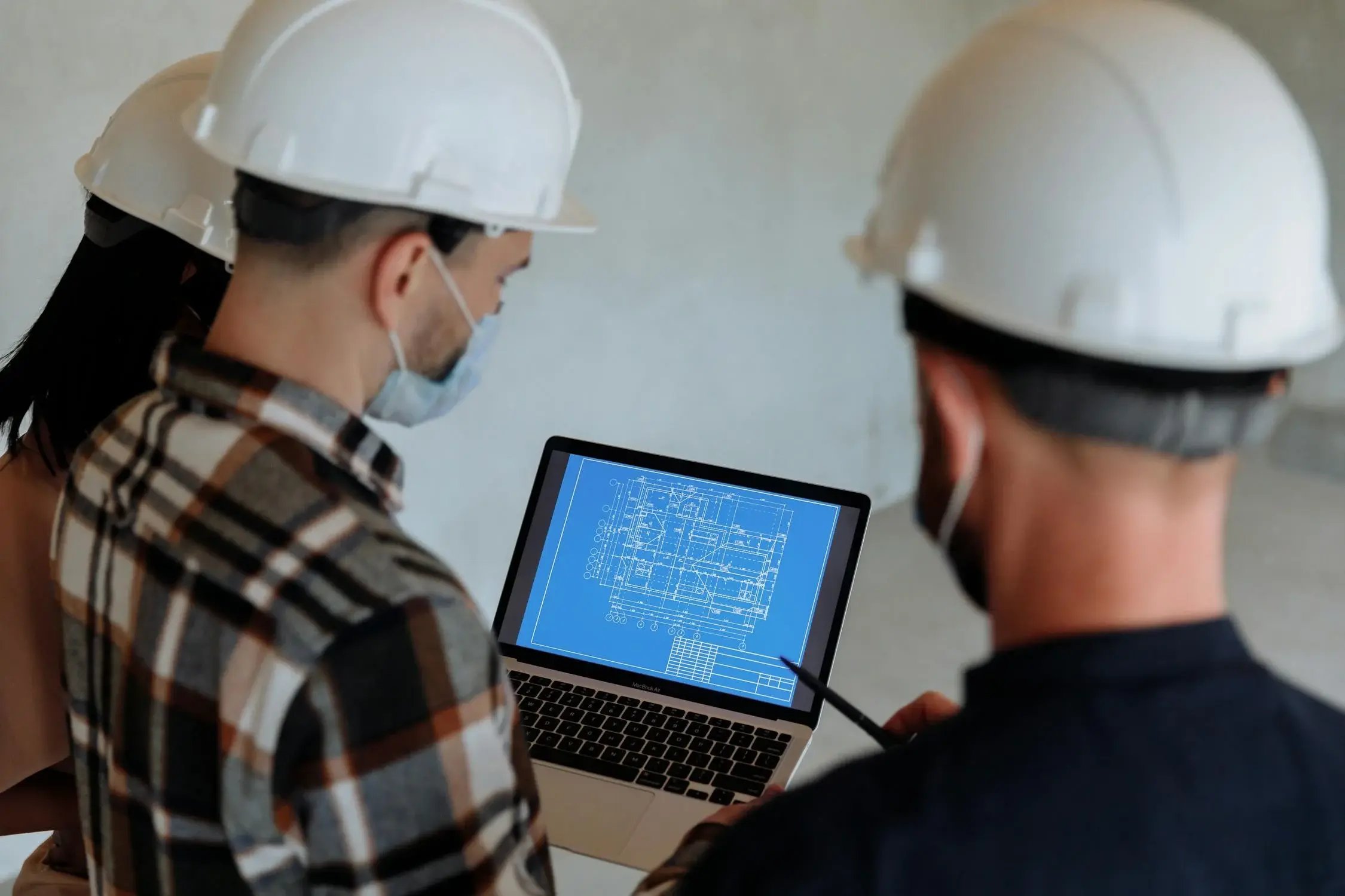 Engineers reviewing building blueprint