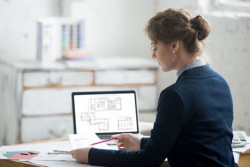 Female architect reviewing the architectural plan 