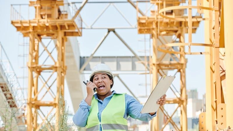 Female construcion management intern taking notes from seniors