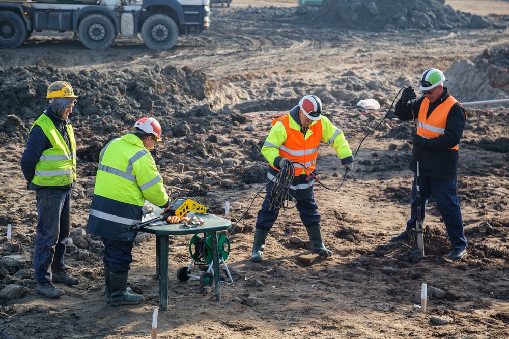 Geotechnical engineers surveying a site