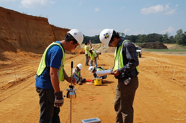 Geotechnical engineers taking site measurements