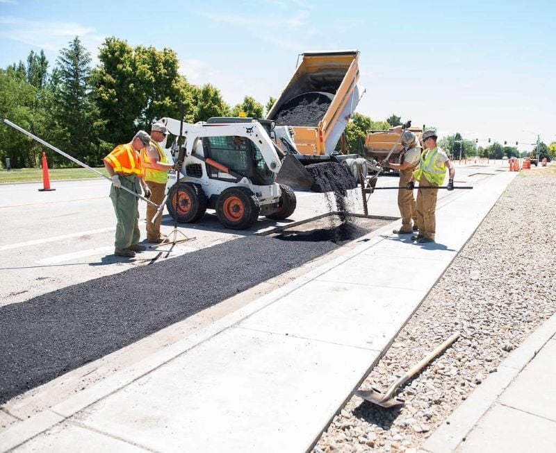 Highway engineers laying asphalt 