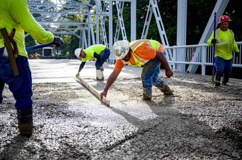 Highway workers leveling concrete