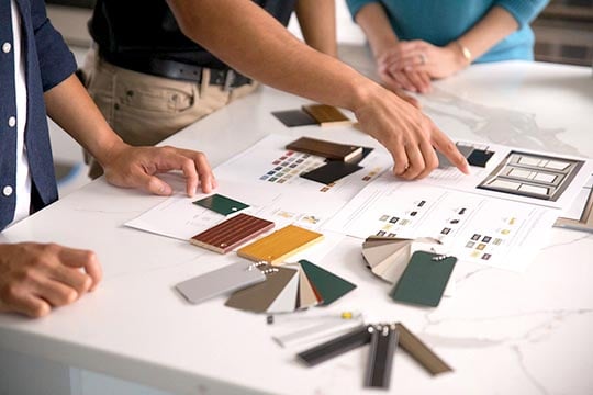 Interior designers selecting material for a space