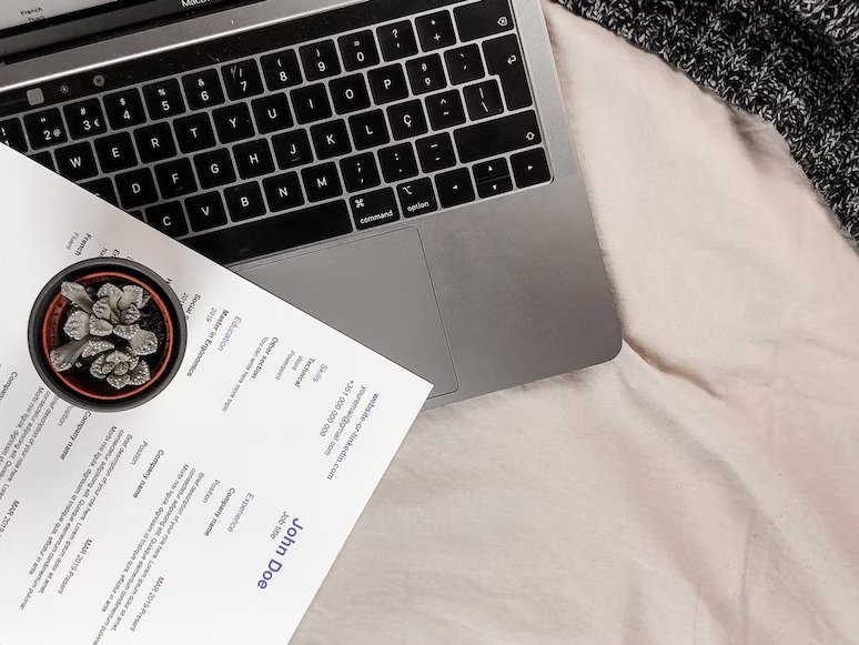 an image of a laptop and a resume