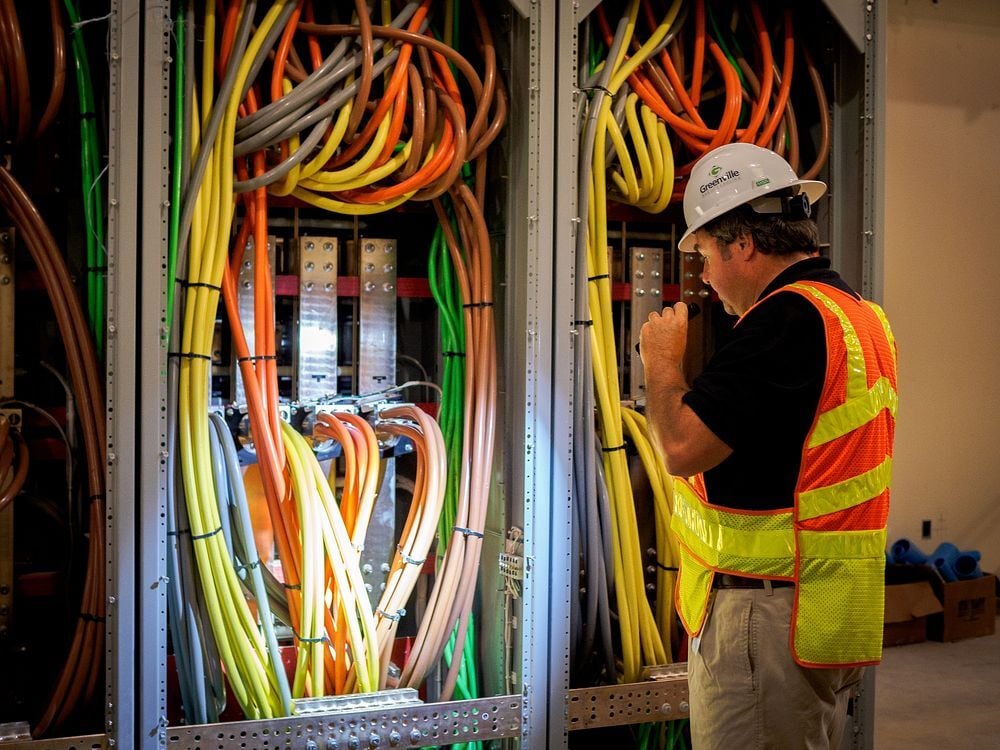 MEP Engineer inspecting an electrical distribution board