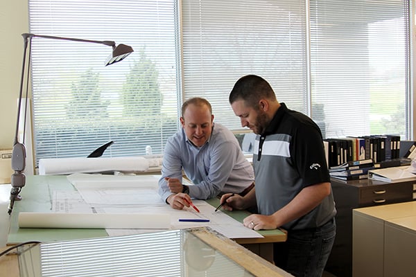 Two landscape architects discussing ideas on a sheet