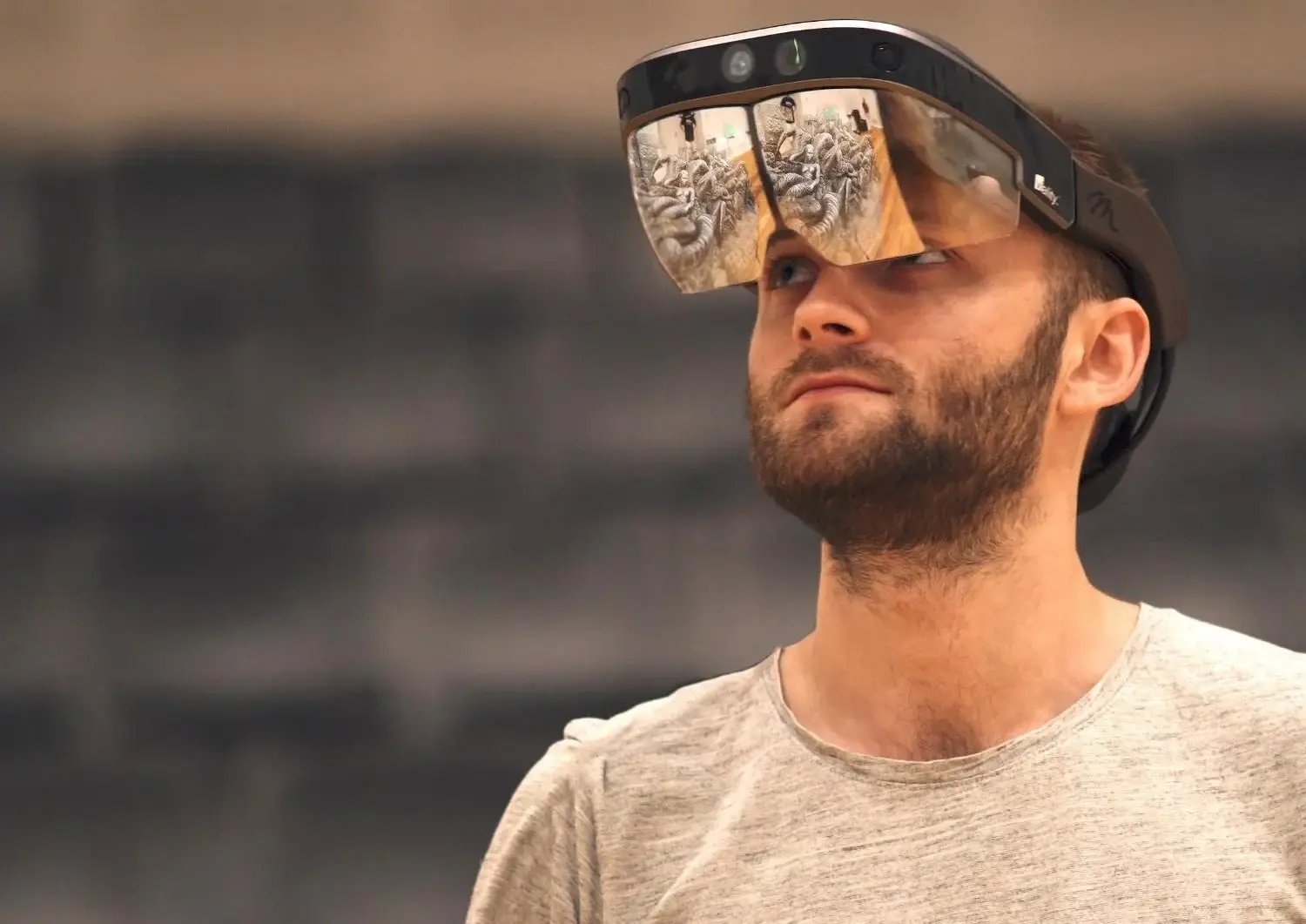 Professional wearing AR glasses for design review.