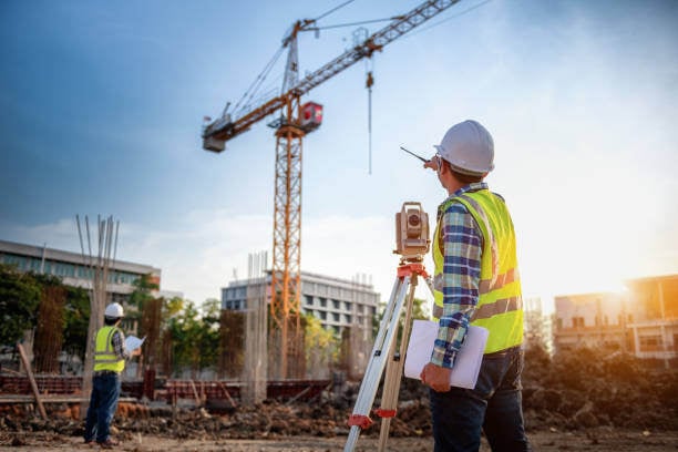 Project Engineer overseeing construction workers working at a construction site