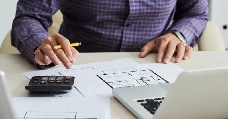 Quantity surveyor calculating project costs