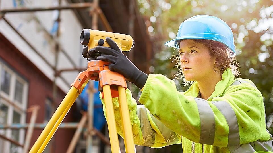 Site engineer surveying the site