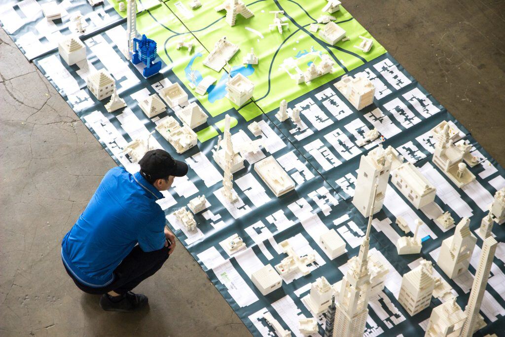 Student in an urban design studio looking at the building designs